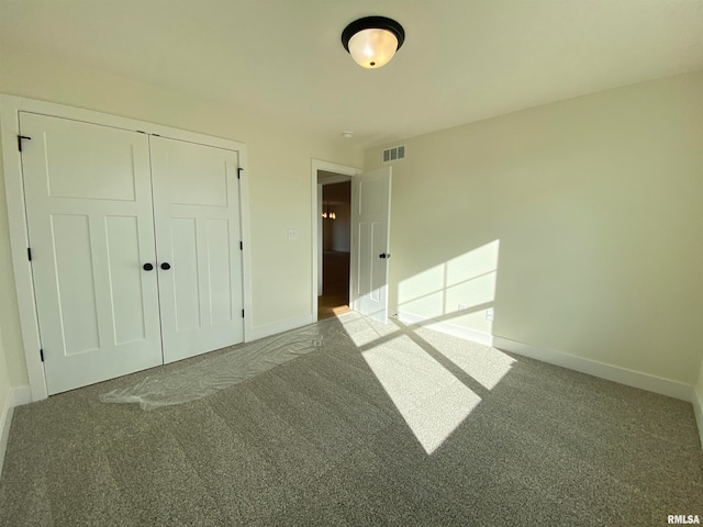 unfurnished bedroom with a closet and carpet floors