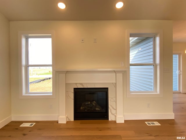 interior details featuring hardwood / wood-style flooring and a fireplace