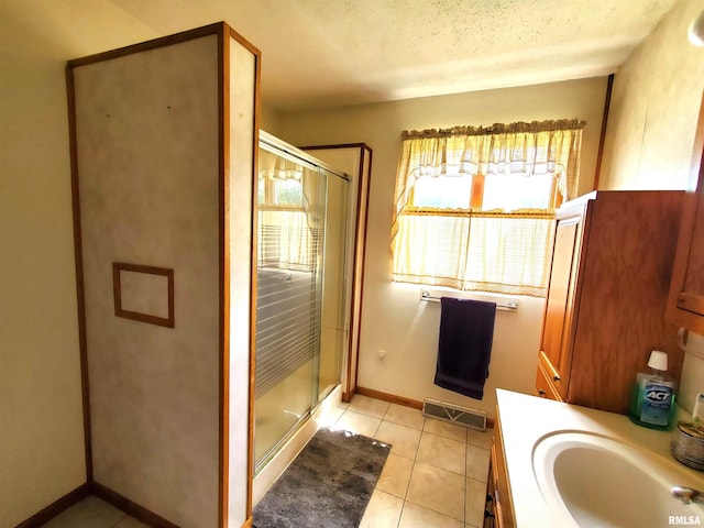 bathroom with walk in shower, vanity, and a wealth of natural light