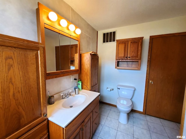 bathroom with tile patterned floors, vanity, and toilet