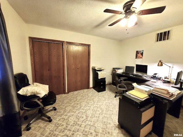 office with light carpet, ceiling fan, and a textured ceiling