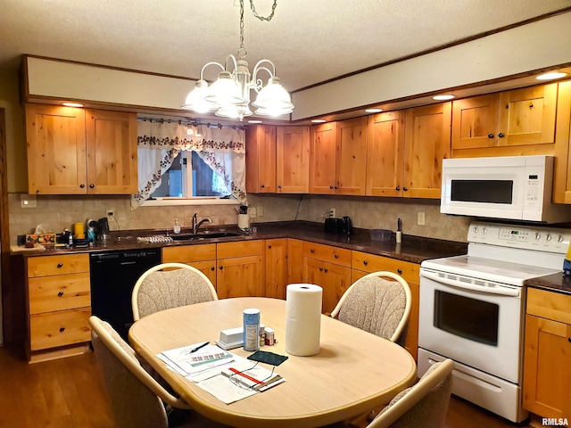 kitchen with sink, white appliances, a textured ceiling, an inviting chandelier, and dark hardwood / wood-style flooring