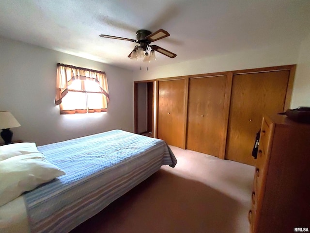 bedroom with two closets and ceiling fan