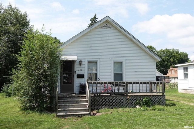 back of house featuring a yard and a deck