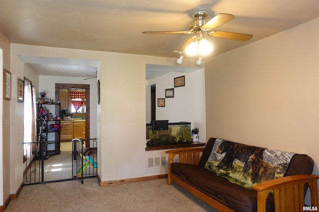 living room with ceiling fan and carpet flooring