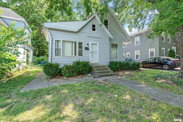 bungalow-style house featuring a front yard