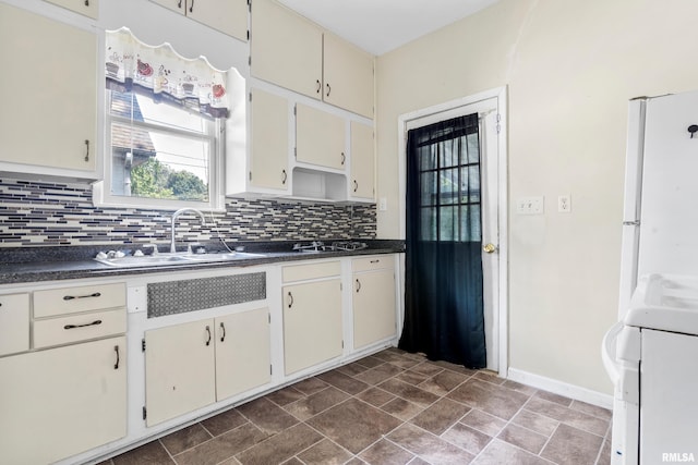 kitchen featuring range, tasteful backsplash, and sink