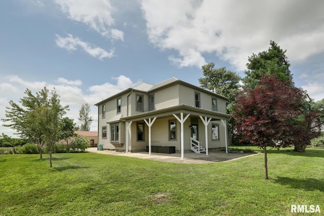 back of property featuring a lawn