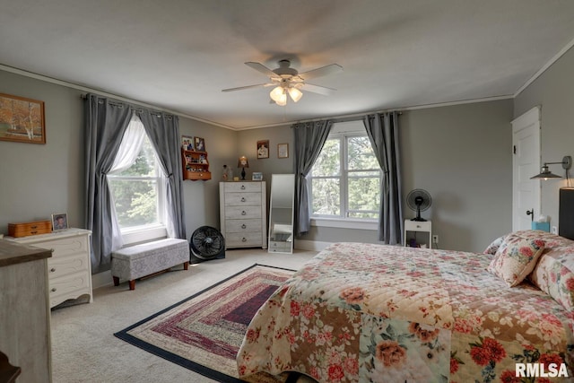 bedroom featuring ceiling fan, ornamental molding, and light carpet