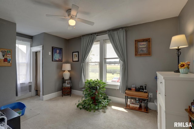 interior space with light carpet and ceiling fan