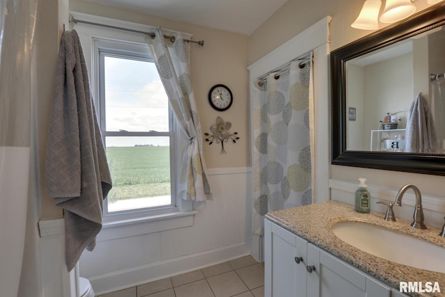 bathroom with toilet, tile patterned floors, and vanity