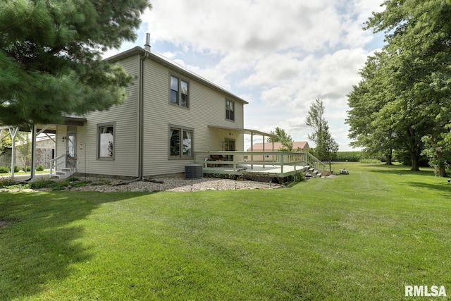 back of house featuring a lawn, central AC unit, and a deck