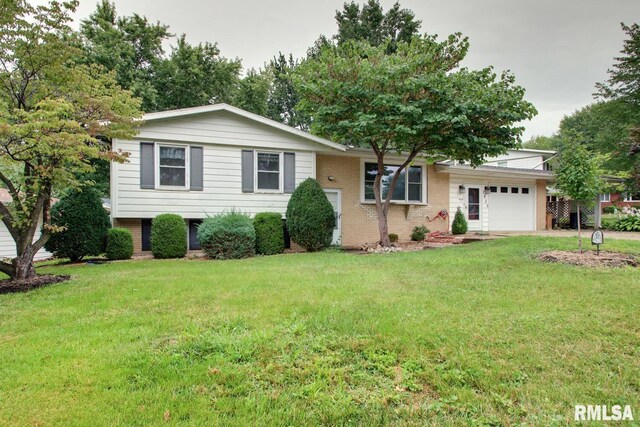 view of front of property with a front lawn and a garage