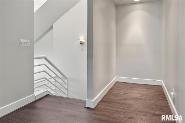 corridor with hardwood / wood-style floors