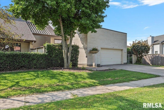 view of front of house featuring a garage and a front lawn