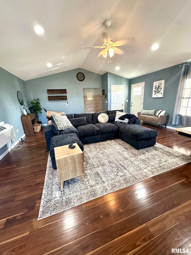 living room with a wall unit AC, wood finished floors, baseboards, lofted ceiling, and ceiling fan