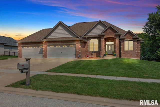 craftsman-style house featuring a garage and a yard