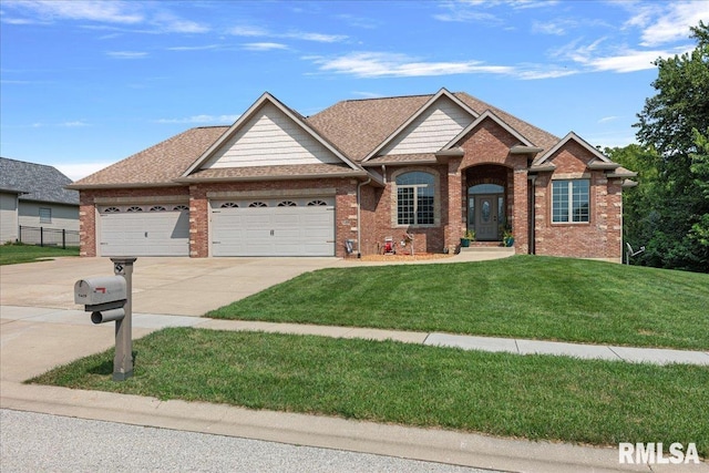 view of front of house featuring a garage and a front lawn