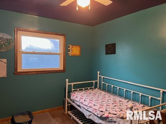 bedroom with wood-type flooring and ceiling fan