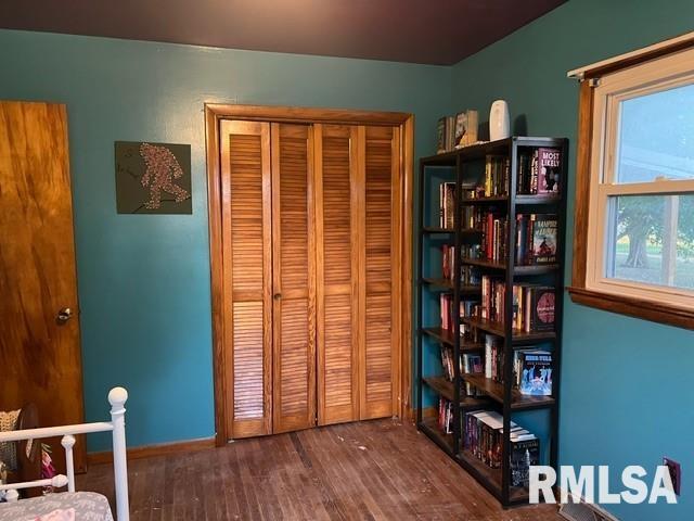 bedroom with dark hardwood / wood-style flooring