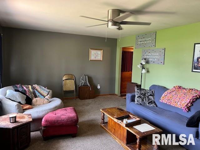 living room featuring ceiling fan and carpet