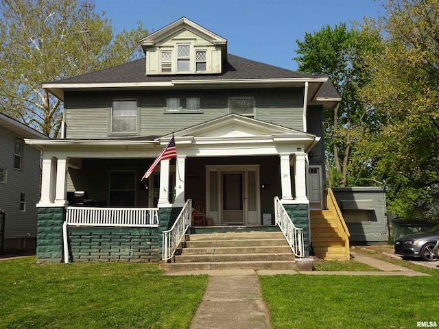 view of front of house with a front yard and covered porch