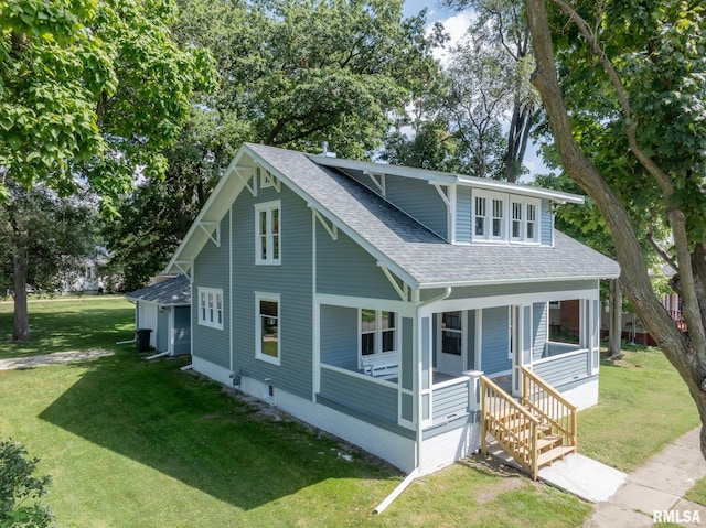 view of front facade with covered porch and a front yard