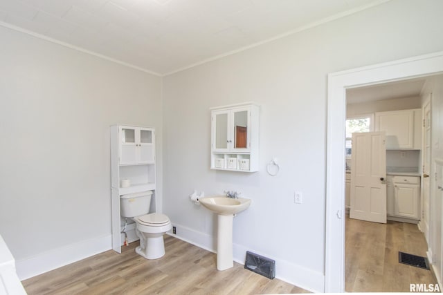 bathroom with sink, toilet, and hardwood / wood-style flooring