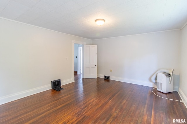 unfurnished room featuring dark hardwood / wood-style flooring and crown molding