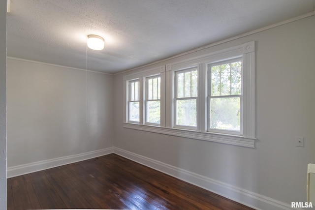 spare room featuring a textured ceiling and dark wood-type flooring