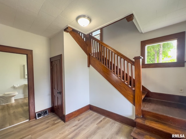 stairway featuring hardwood / wood-style flooring