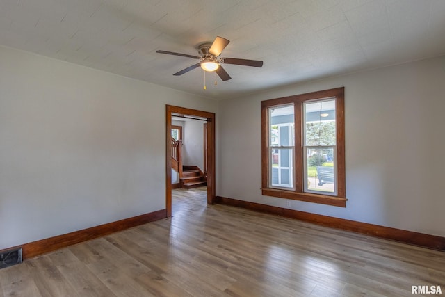 unfurnished room with light hardwood / wood-style flooring and ceiling fan