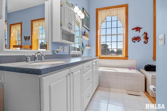 bathroom featuring vanity, tile patterned floors, and tiled tub