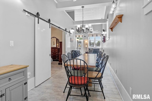 dining area with a barn door and a notable chandelier