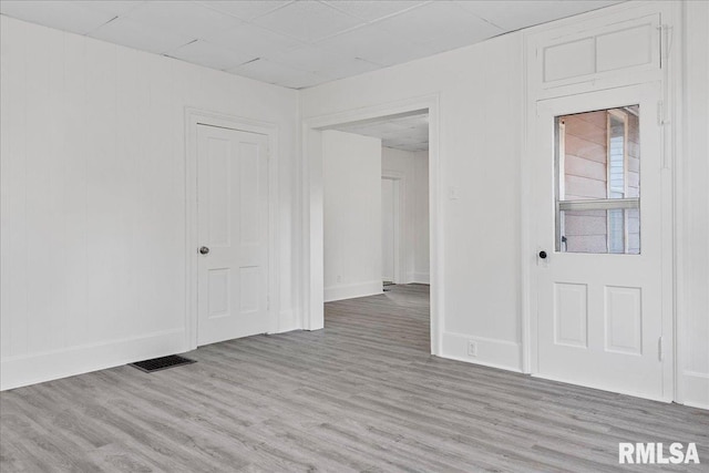 empty room with light hardwood / wood-style flooring