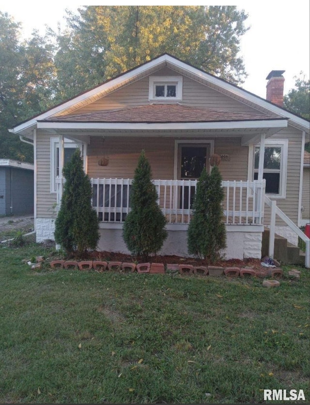 bungalow-style home featuring a porch and a front lawn