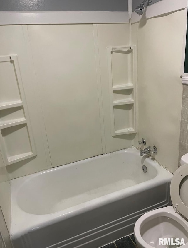 bathroom featuring toilet, tile patterned floors, and bathing tub / shower combination