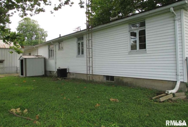 exterior space with a yard, central AC unit, and a shed