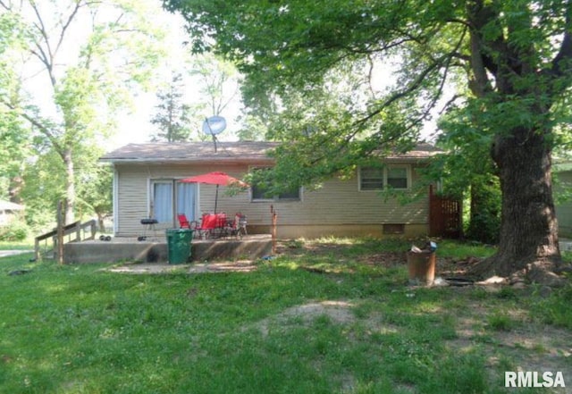 rear view of house featuring a lawn