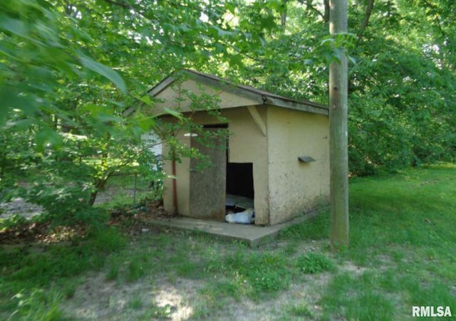 view of outdoor structure with a lawn