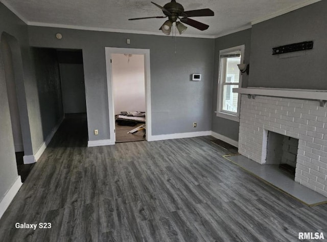 interior space featuring a fireplace, dark wood-type flooring, a textured ceiling, and ceiling fan