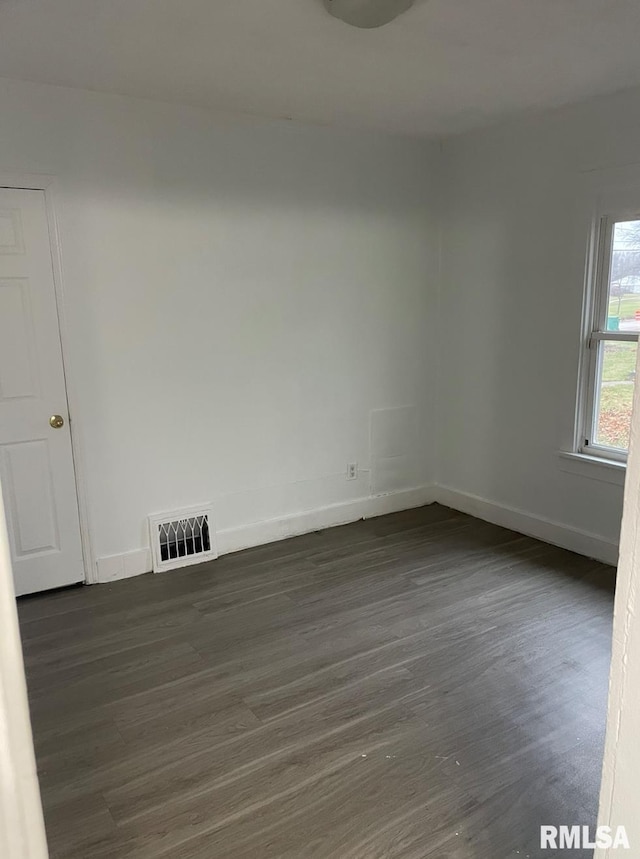 empty room with dark wood-type flooring