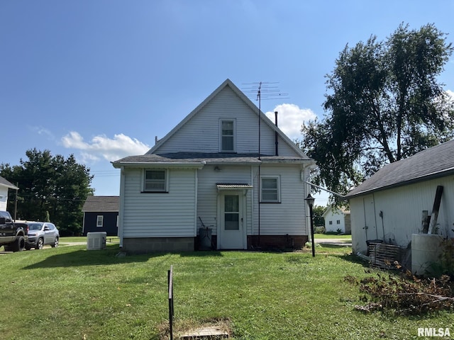 back of house with a lawn and central AC