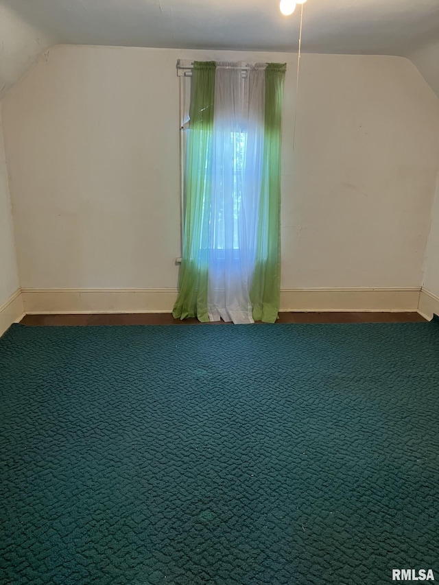 bonus room with lofted ceiling and carpet