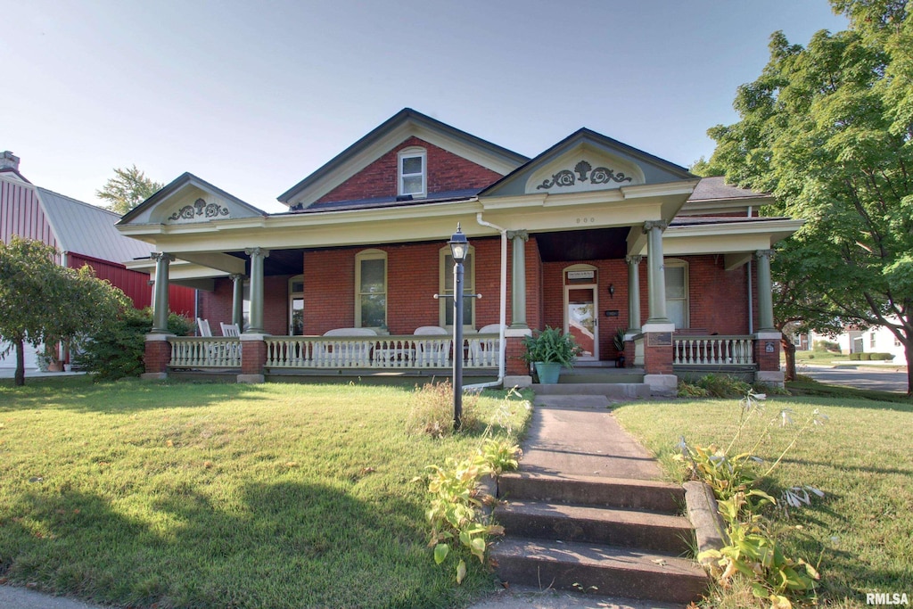 view of front of property with a porch and a front yard