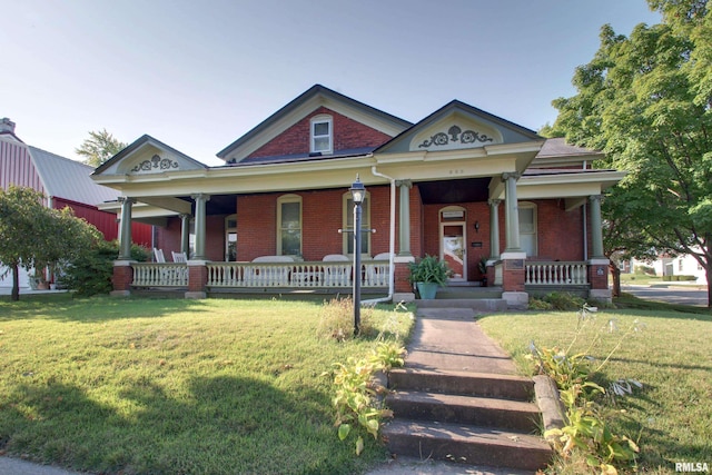 view of front of property with a porch and a front yard