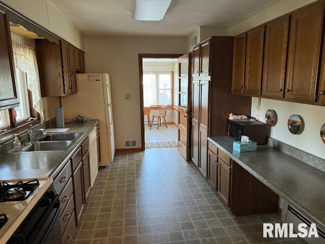 kitchen with baseboard heating and sink