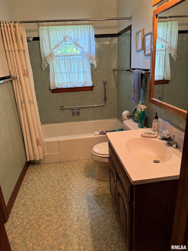 full bathroom with a wealth of natural light, vanity, toilet, and tile walls