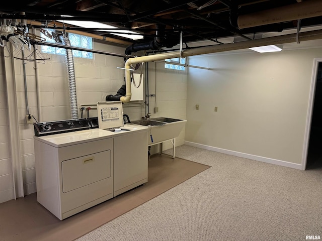 clothes washing area with washing machine and clothes dryer and light colored carpet