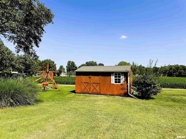 view of outdoor structure with a playground and a lawn